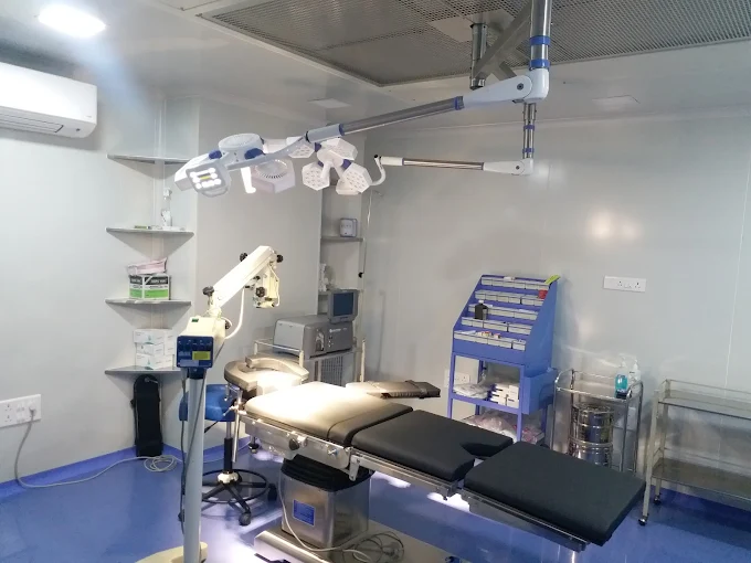 Operation theatre with surgical microscope and overhead lights at Dr. Murkute's O2 Bone & Eye Care Clinic